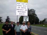 Harrington Police Chief, Mark Anderson (left) joins Commissioner Harold Brode, Rep. Bobby Outten, Fire Policeman Joe Zeroles and Andrea Summers of the Office of Highway Safety in marking the first road signs warning motorists to move over